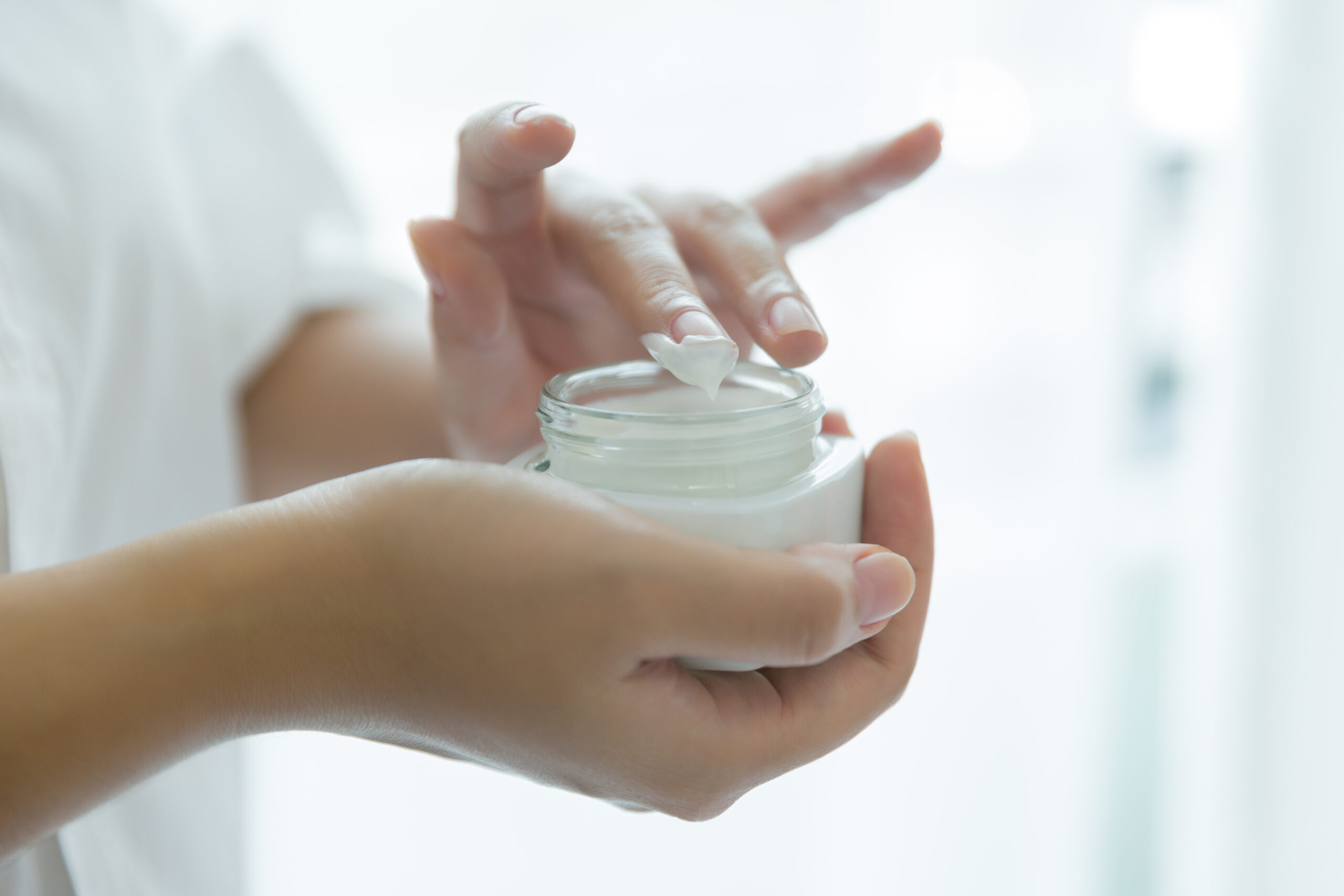 woman holds a jar with a cosmetic cream in her hands. skin care